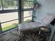 Relaxing sun room retreat with daybed, area rug, and views at 708 Tamiami S Trl # 216, Venice, FL 34285