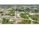 A bird's-eye view reveals the property's layout, backyard pool, and placement within a peaceful, green neighborhood at 7180 Quarry St, Englewood, FL 34224
