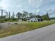 Spacious backyard features mature trees, a storage shed, and a well-maintained lawn area at 7180 Quarry St, Englewood, FL 34224