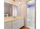 A bathroom with white cabinets, a sink, vanity, a mirror and a shower at 7180 Quarry St, Englewood, FL 34224