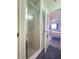 Shower stall in a bathroom with a view to the bedroom through a doorway at 7180 Quarry St, Englewood, FL 34224