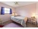 A bedroom with neutral walls and floor, a window, ceiling fan, and natural light at 7180 Quarry St, Englewood, FL 34224