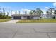 Charming single-story home featuring a well-manicured lawn, attached two-car garage, and classic design at 7180 Quarry St, Englewood, FL 34224