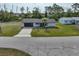 Cozy home featuring an attached garage, a spacious driveway, and a well-kept lawn for comfortable living at 7180 Quarry St, Englewood, FL 34224