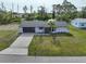 Cozy home featuring an attached garage, a spacious driveway, and a well-kept lawn for comfortable living at 7180 Quarry St, Englewood, FL 34224