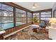 Relaxing Florida room with a rocking chair and views of the screened-in pool at 7180 Quarry St, Englewood, FL 34224