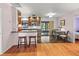 Open-concept kitchen featuring stainless steel appliances and a breakfast bar, flowing into dining area at 7180 Quarry St, Englewood, FL 34224