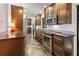 Modern kitchen featuring wood cabinetry, granite countertops, and stainless steel appliances at 7180 Quarry St, Englewood, FL 34224