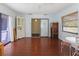 Bright living room with hardwood floors, multiple windows, and glass door access to the outside at 7180 Quarry St, Englewood, FL 34224