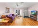 Cozy living room featuring hardwood floors, comfortable furniture, and natural light at 7180 Quarry St, Englewood, FL 34224