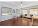Sun-filled living area with hardwood floors and multiple windows providing ample natural light at 7180 Quarry St, Englewood, FL 34224
