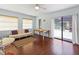 Bright living room with hardwood floors and sliding doors providing a view of a pool at 7180 Quarry St, Englewood, FL 34224