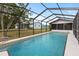 Inviting swimming pool with screened enclosure and tile trim at 7180 Quarry St, Englewood, FL 34224