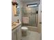 Bathroom featuring glass enclosed shower, single sink vanity, medicine cabinet, and toilet at 786 Heathercreek Ct, Englewood, FL 34223