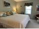 Cozy bedroom featuring soft lighting, a comfortable bed, and tasteful decor, creating a relaxing retreat at 786 Heathercreek Ct, Englewood, FL 34223