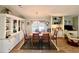 Dining room featuring a dining table with seating for six and built in display cabinets at 786 Heathercreek Ct, Englewood, FL 34223