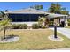 Charming single-story home featuring a covered parking area and meticulously maintained landscaping at 786 Heathercreek Ct, Englewood, FL 34223