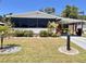 Charming single-story home featuring a covered parking area and meticulously maintained landscaping at 786 Heathercreek Ct, Englewood, FL 34223