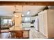 Well-lit kitchen with modern appliances, tile flooring, and ample counter space with breakfast bar at 786 Heathercreek Ct, Englewood, FL 34223