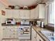 Well-lit kitchen boasts white cabinets, appliances, and ample counter space at 786 Heathercreek Ct, Englewood, FL 34223