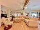 Bright living room with wood floors, a large sectional sofa, and natural light at 786 Heathercreek Ct, Englewood, FL 34223