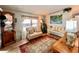 Cozy living room features a comfortable sofa, vintage-style furnishings, and a decorative area rug at 786 Heathercreek Ct, Englewood, FL 34223