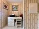 Office nook with neutral wallpaper, a desk and chair, and overhead lighting at 786 Heathercreek Ct, Englewood, FL 34223