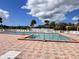 Community pool area with lounge chairs, multiple pools and tropical palm trees at 786 Heathercreek Ct, Englewood, FL 34223