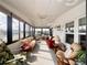 Bright sunroom with lots of windows, a ceiling fan, and comfortable furniture at 786 Heathercreek Ct, Englewood, FL 34223