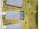 Aerial view of the backyard, including the screened in pool and surrounding greenery at 8244 Shore Lake Dr, Englewood, FL 34224