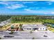 An aerial view showcases the clubhouse, pool, playground, and surrounding greenery at 8244 Shore Lake Dr, Englewood, FL 34224