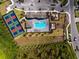 Aerial view of the community pool, clubhouse, playground, and pickleball courts at 8244 Shore Lake Dr, Englewood, FL 34224