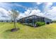 The backyard has a screened in pool, landscaping, and backyard trees at 8244 Shore Lake Dr, Englewood, FL 34224