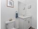 Well lit bathroom with a single vanity, framed wall art and a decorative towel rack at 8244 Shore Lake Dr, Englewood, FL 34224