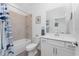 Bright bathroom featuring a combined tub and shower and white vanity at 8244 Shore Lake Dr, Englewood, FL 34224