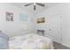 Well lit bedroom with hardwood floors and a ceiling fan at 8244 Shore Lake Dr, Englewood, FL 34224