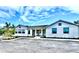 Beautiful community clubhouse with a social room and lovely green landscaping at 8244 Shore Lake Dr, Englewood, FL 34224