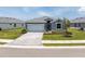 Well manicured yard with tropical foliage and a paved driveway at 8244 Shore Lake Dr, Englewood, FL 34224