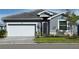 Charming single-Gathering home with a two-car garage, well-maintained lawn, and inviting front entrance at 8244 Shore Lake Dr, Englewood, FL 34224