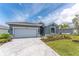 Charming single-story home features a paved driveway and beautifully landscaped yard at 8244 Shore Lake Dr, Englewood, FL 34224