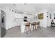 Modern kitchen featuring a kitchen island with chairs and stainless steel appliances at 8244 Shore Lake Dr, Englewood, FL 34224