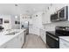 Bright kitchen featuring white cabinets, stainless steel appliances, and quartz countertops at 8244 Shore Lake Dr, Englewood, FL 34224