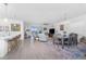 Open-concept living and dining area featuring lots of seating and hardwood flooring at 8244 Shore Lake Dr, Englewood, FL 34224