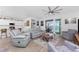 Bright living room with stylish furniture, views of pool, and an open layout to the kitchen at 8244 Shore Lake Dr, Englewood, FL 34224
