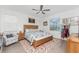 Comfortable main bedroom with natural light, ceiling fan, and decorative accents at 8244 Shore Lake Dr, Englewood, FL 34224