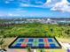 Aerial view of four community pickleball courts with vibrant blue and red playing surfaces near the ocean at 8244 Shore Lake Dr, Englewood, FL 34224