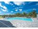 The community's large pool is lined with deck chairs and mature landscaping at 8244 Shore Lake Dr, Englewood, FL 34224