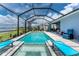 Beautiful screened-in pool area with relaxing lounge chairs, ideal for enjoying sunny days by the water at 8244 Shore Lake Dr, Englewood, FL 34224