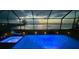 Beautiful screened-in pool area with hot tub overlooking tranquil lake at 8244 Shore Lake Dr, Englewood, FL 34224