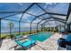 Inviting screened-in pool area with comfortable lounge chairs and scenic lake views at 8244 Shore Lake Dr, Englewood, FL 34224